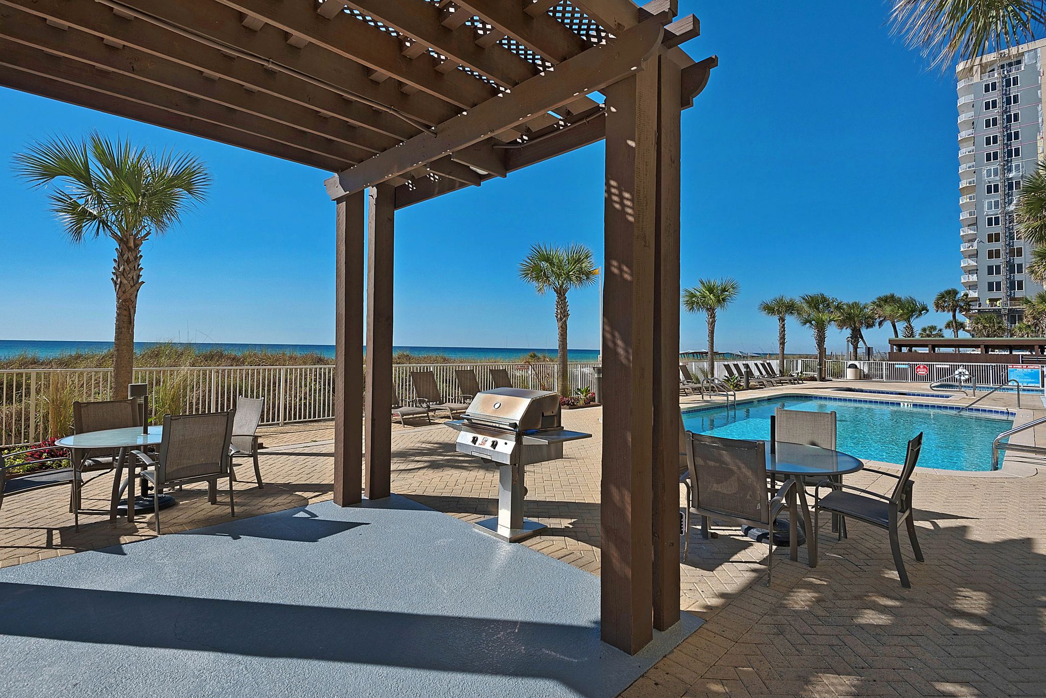 Shared amenity at Ocean Villa, Panama City Beach -- the owners captioned this photo "Anyone for poolside grilling?!?!"